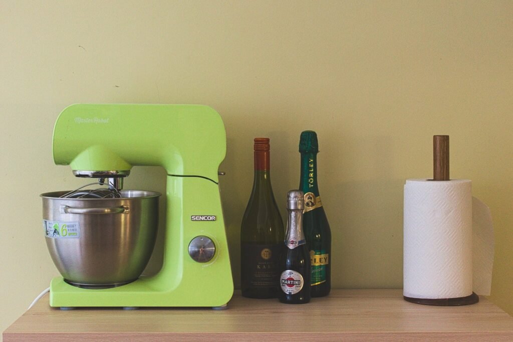 A lime green standing mixer on a table