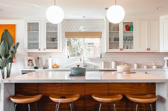 Exposed brick and natural stone backsplashes offer a charming and timeless aesthetic