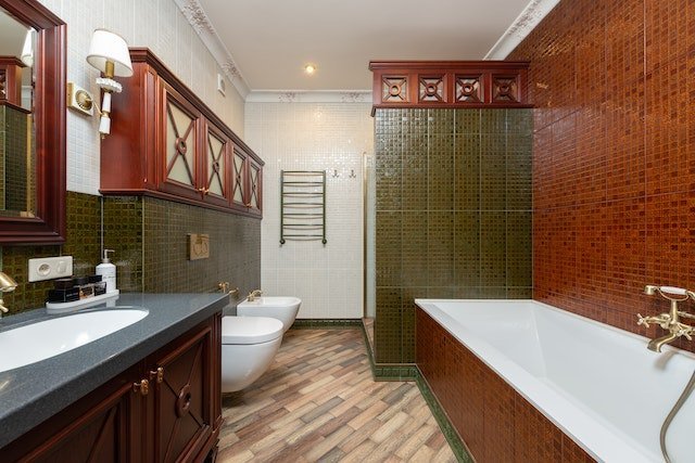 Red wooden cabinets above the toilets