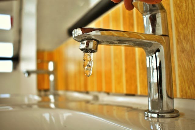 A close-up of a faucet with flowing water