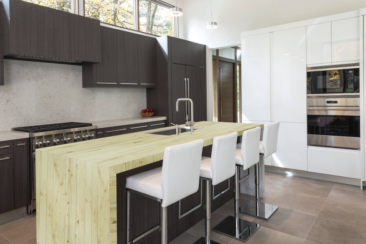 Minimalist kitchen with dark grey cabinets, light wood table and white chairs