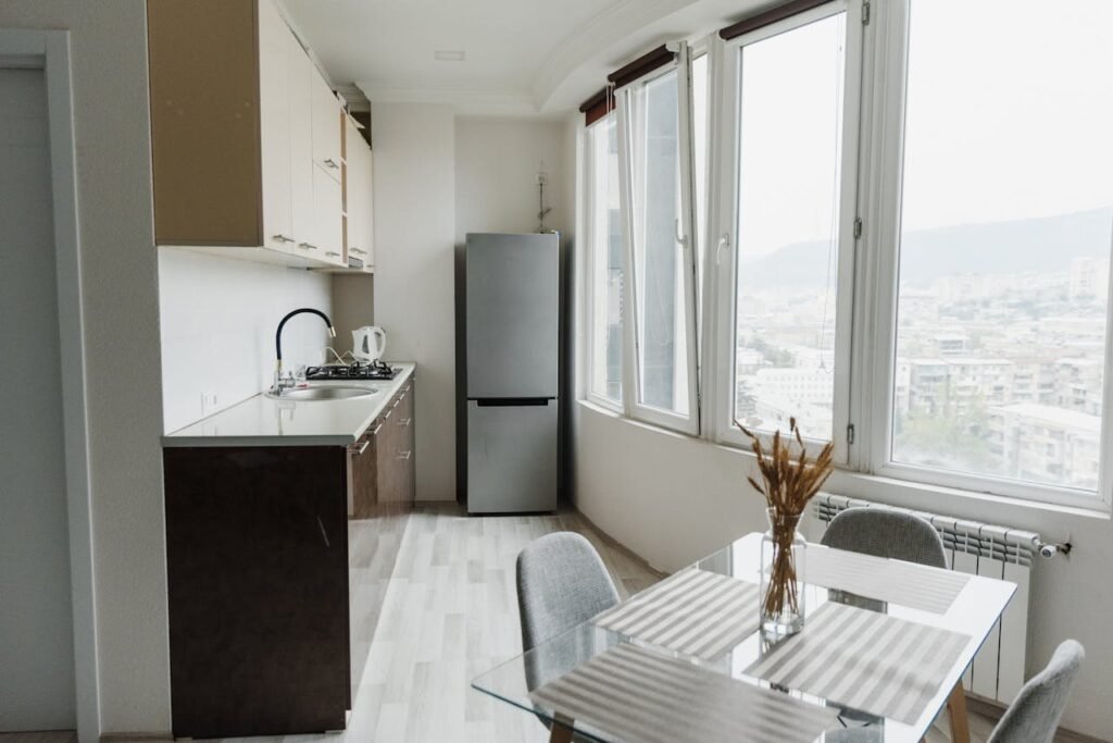 Small kitchen on a balcony, with a view of apartment blocks