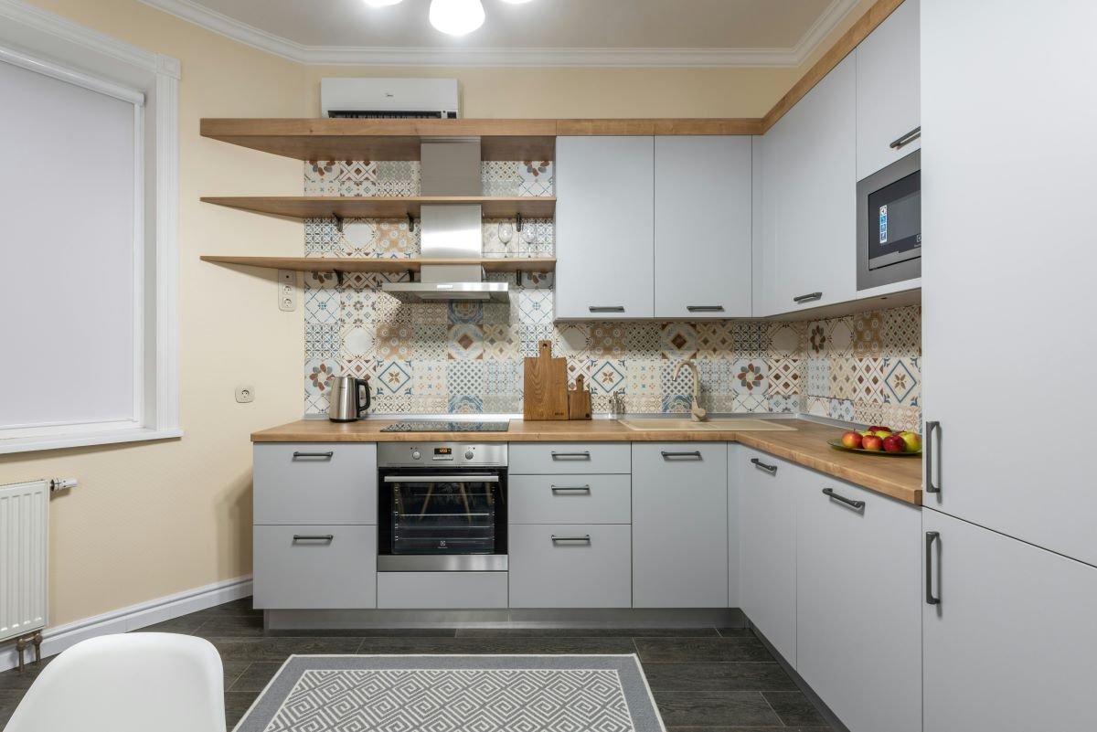 Modern kitchen with open shelves and smart cabinetry showcasing storage hacks for your kitchen appliances in a sleek design.