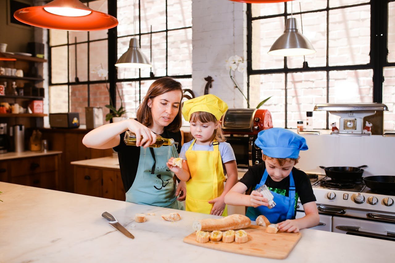 Woman with two kids cooking on a marble kitchen counter