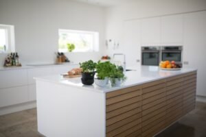 White kitchen, white countertop, aromatic herbs, bread, fruit